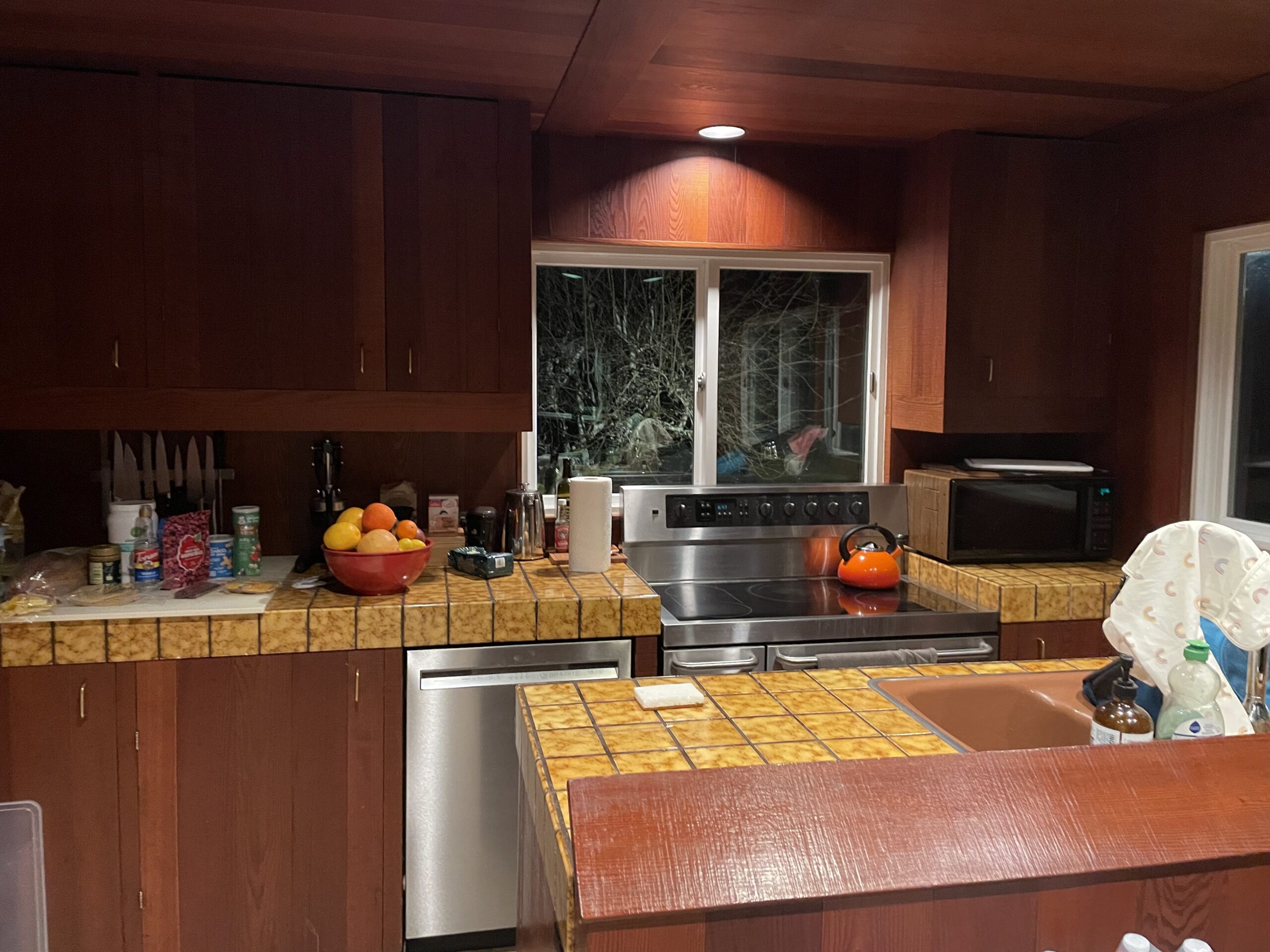60s cabin kitchen with wood panel and mustard yellow tile