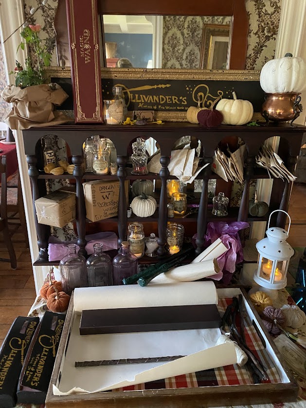 Ollivanders Wand Shop with wand boxes, wands, potions, letters, scrolls, quills, pumpkins, lanterns for an entryway welcome for a Harry Potter party