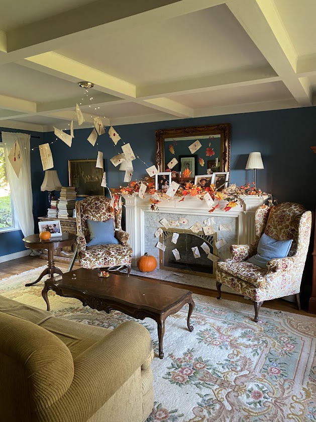 The Dursley's living room at number 4 privet drive set up for a Harry Potter party with Hogwarts letters flying around the room