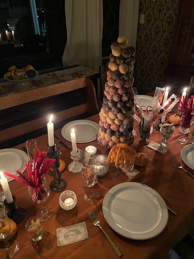 The Great Hall table with candies, plates, candlesticks, donut tower, plates, forks