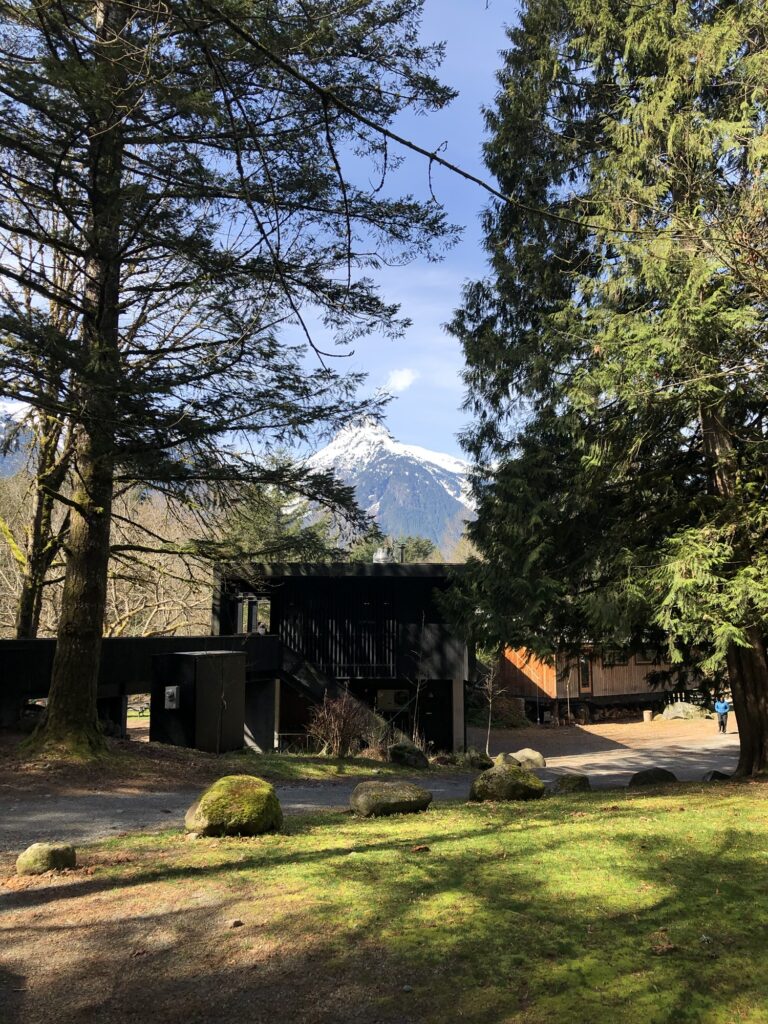 Sunwolf cabin rentals in Squamish with main building and large snow capped mountain behind